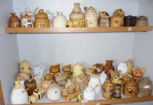 Large collection of novelty china & pottery honey pots (two shelves)