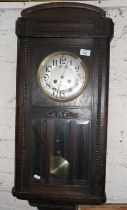 Oak cased 8-day wall clock, striking on a gong with glass door enclosing pendulum