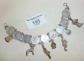 Silver and coin bracelet hung with various charms, c. 1940's/50's. Approx. weight 36.5g and 18cm