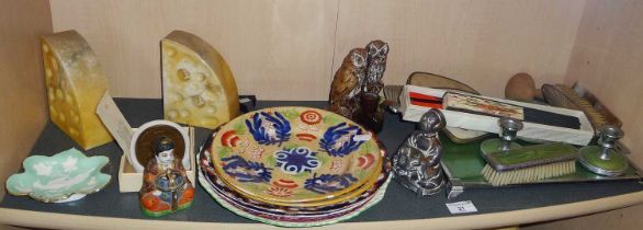 Shelf of mixed items including Buddhas, alabaster bookends in the form of Edam cheese wedges with