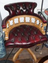 Reproduction button backed red leatherette revolving Captain's chair