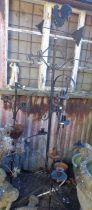 Pair of wrought iron garden 5-branch candle stands and a similar with weather vane and cockerel to