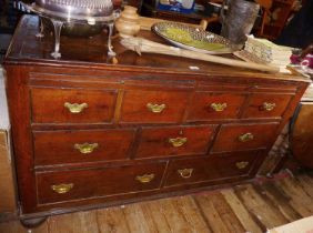 18th c. panelled oak low dresser with two dummy drawer cupboards above five drawers with brass