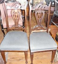 Pair of Art Nouveau mahogany chairs with shaped backs and upholstered seats