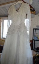 Vintage clothing:- a bridal gown and a crochet-work bedspread