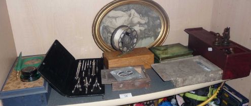 Two sets of metal letter stencils, a cased set of drawing instruments, a Mercury fishing reel, a