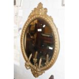 Victorian gilt and gesso oval girondelle wall mirror with bevelled edge glass