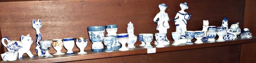 Collection of blue & white china egg cups with similar figurines etc