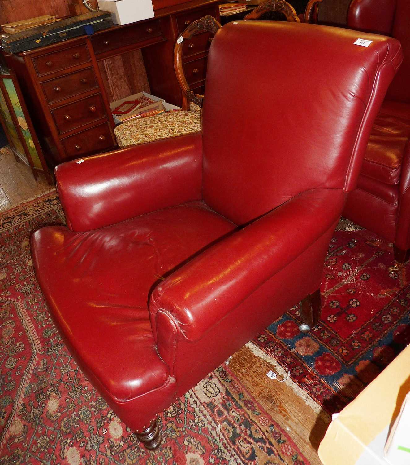 Edwardian red leather upholstered club armchair on turned feet