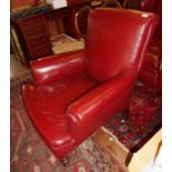 Edwardian red leather upholstered club armchair on turned feet