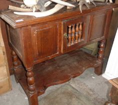 19th c. small oak dresser having single door with chicken coop turnings above shaped undertier,