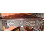 Victorian gothic carved oak corner shelf having bold carving of grotesque masks flanking a single