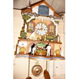 Novelty automaton cuckoo clock "Spirit of Bowls" with moving bowlers from a Bowls Club building