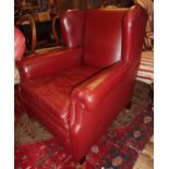 Edwardian wing back red leather upholstered armchair on square tapering feet