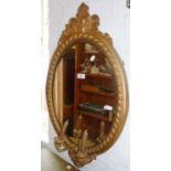 Victorian gilt and gesso oval girondelle wall mirror with bevelled edge glass