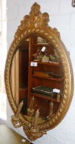 Victorian gilt and gesso oval girondelle wall mirror with bevelled edge glass