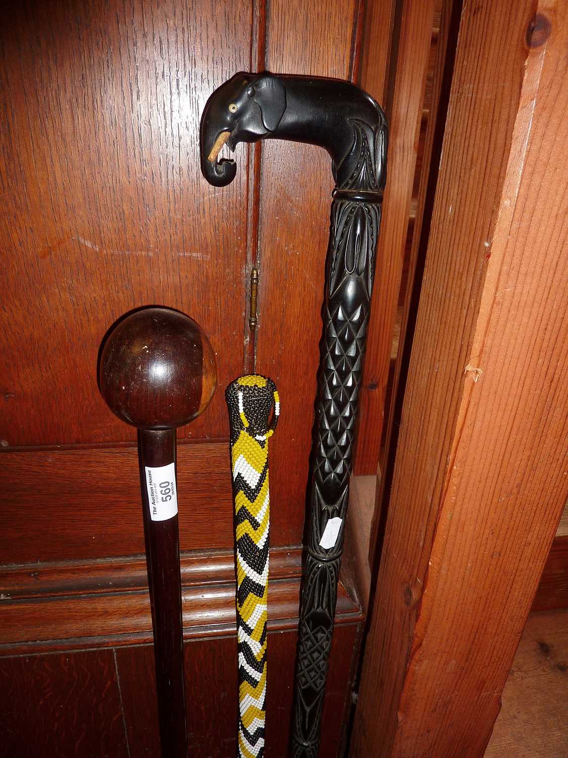 Tribal Art - African knobkerrie throwing club, later bead covered walking stick and another with