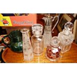 Four cut & etched glass decanters, claret jug, and green glass water jug