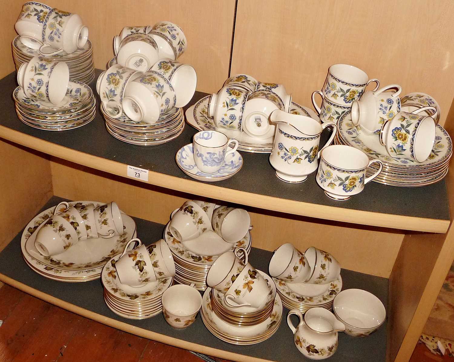 Extensive Paragon "Contessa" teaset and a similar Royal Doulton "Larchmont" teaset (two shelves)