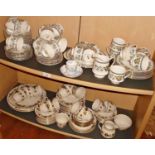 Extensive Paragon "Contessa" teaset and a similar Royal Doulton "Larchmont" teaset (two shelves)