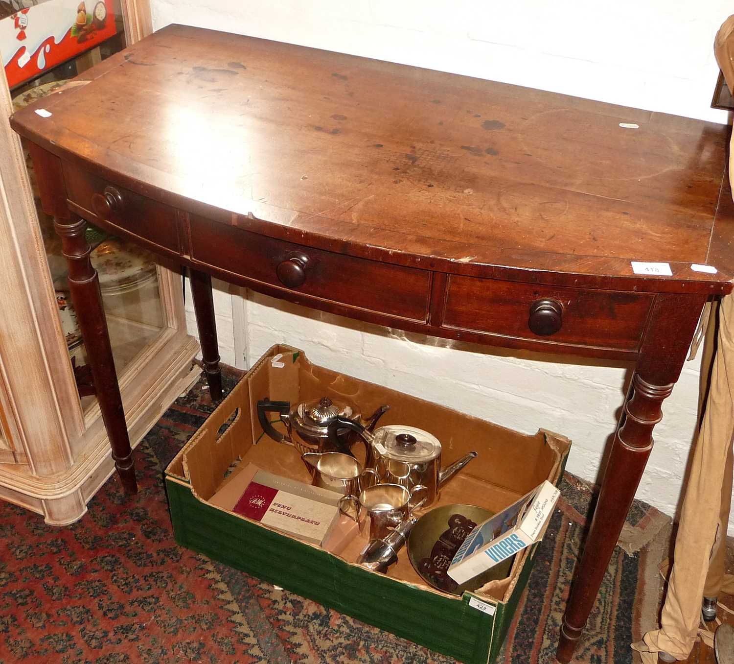 19th c. bow fronted hall table having three drawers above turned legs