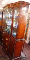 Edwardian mahogany breakfront bookcase with glazed bow fronted upper section above three drawers