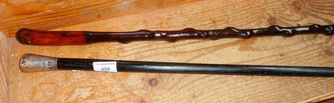 Two walking canes, one antique with silver top