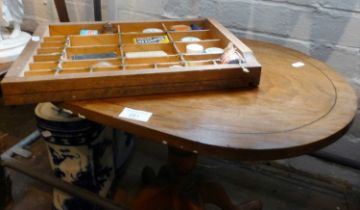 Walnut tripod coffee table and a collection of advertising tins and bottles, etc.