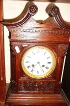 Victorian carved oak mantle clock with swan necked pediment having French movement striking on a