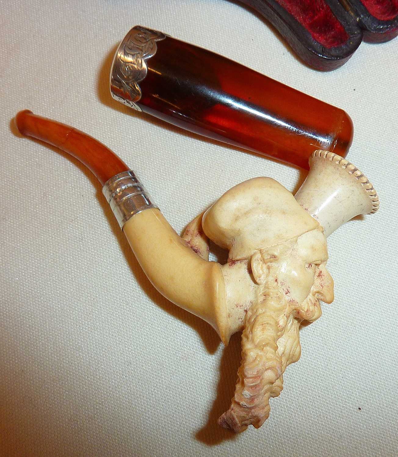 Meerschaum pipe in case carved in the form of an arab gentleman, together with an amber and silver - Image 2 of 2