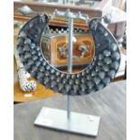 Tribal Art: a Miao silver metal body ornament displayed on stand