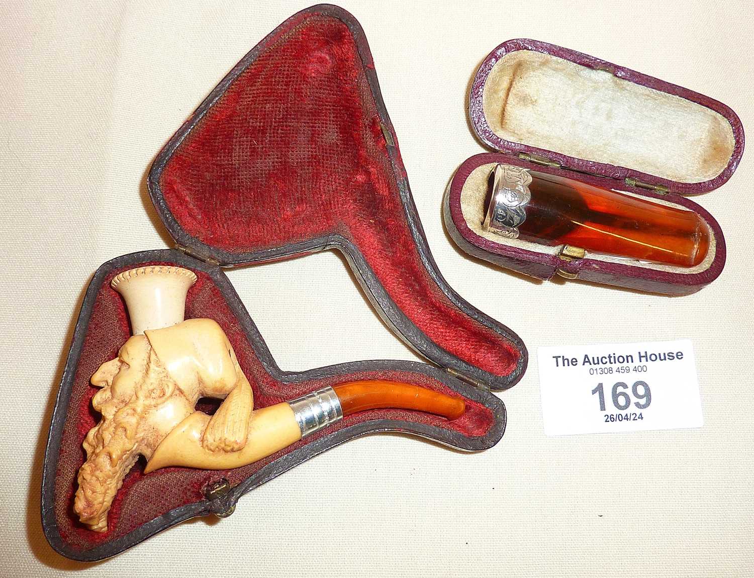 Meerschaum pipe in case carved in the form of an arab gentleman, together with an amber and silver