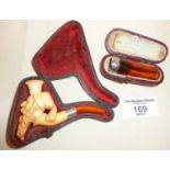 Meerschaum pipe in case carved in the form of an arab gentleman, together with an amber and silver