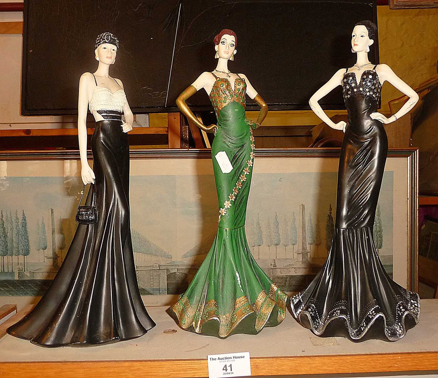 Three resin figures of women in evening dress, 34cm high