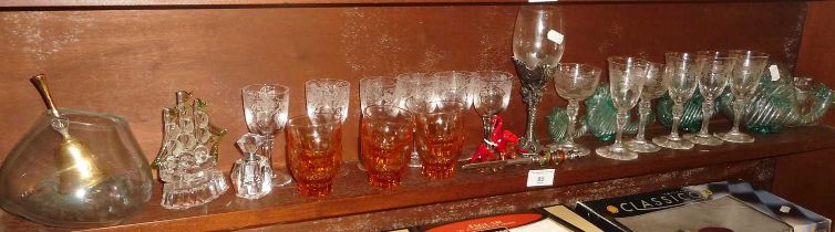 Shelf of etched wine glasses and other glassware