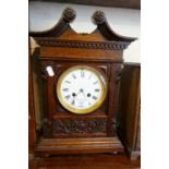 Victorian carved oak mantle clock with swan neck pediment having French movement, striking on a