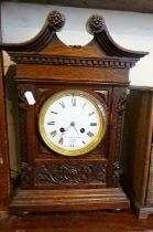 Victorian carved oak mantle clock with swan neck pediment having French movement, striking on a