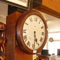 Old school wall clock in circular oak case by John Garnett, London