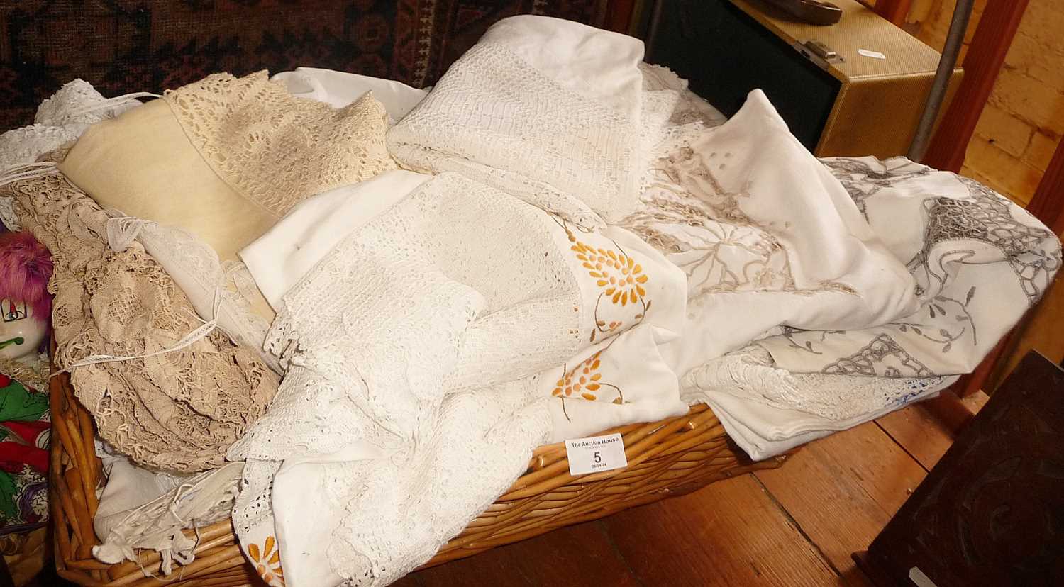 Basket of assorted linen, mostly table linen