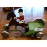 Old clockwork tin plate horse with rider pulling a trotting cart