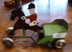 Old clockwork tin plate horse with rider pulling a trotting cart
