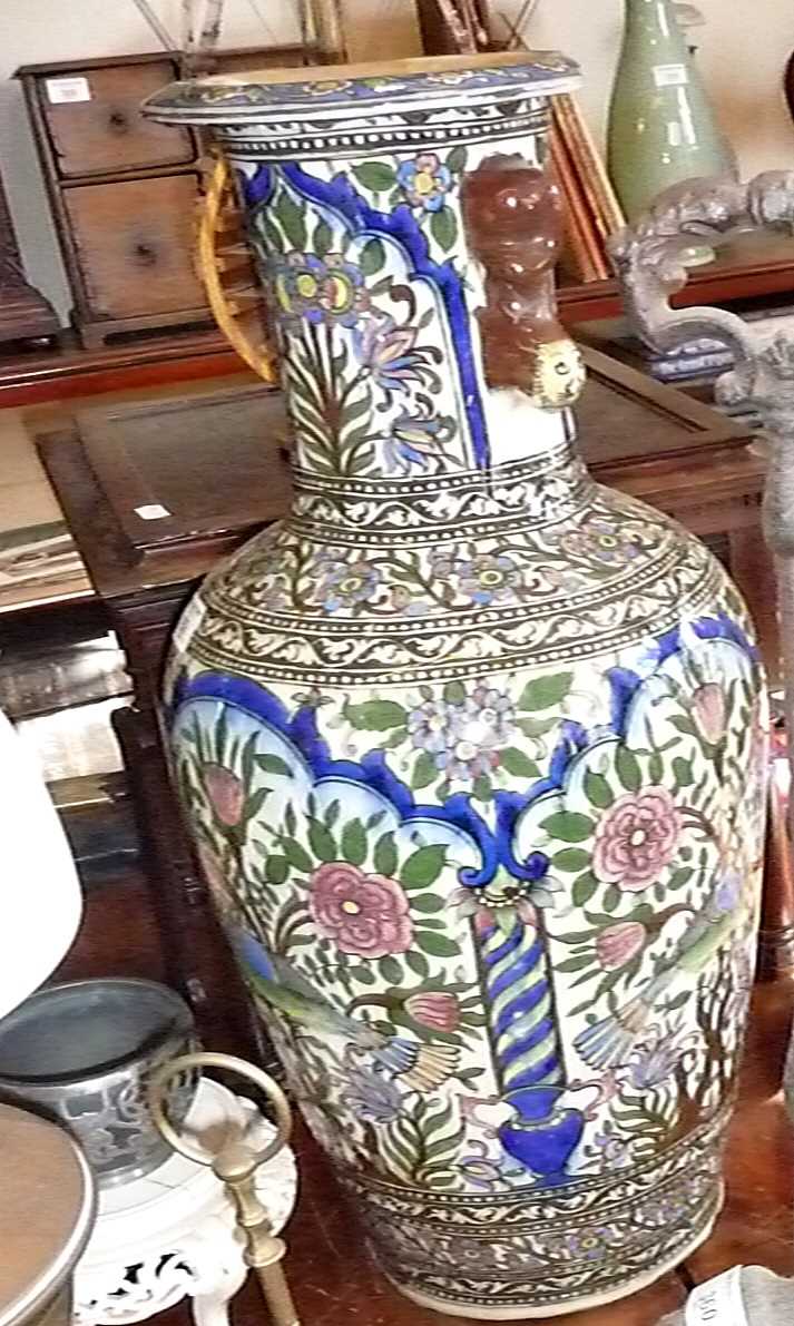 A large Persian Qajar vase polychrome floral pattern baluster, the handles fashioned as recumbent