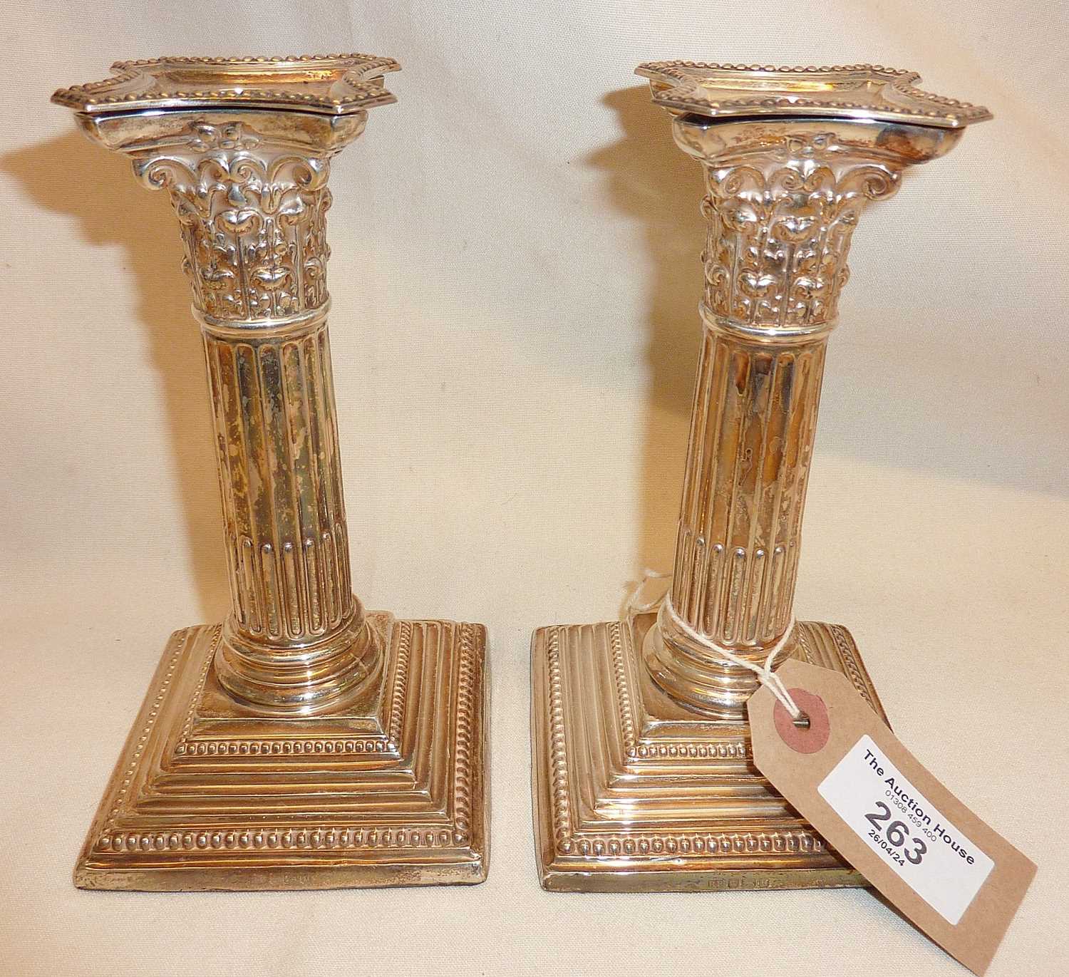 Pair of Edwardian silver columnar candlesticks with weighted bases. Approx. 16cm high and hallmarked