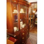 Edwardian mahogany breakfront bookcase with glazed bow fronted upper section above three drawers