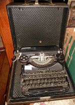 A vintage Corona portable typewriter in black enamel with case