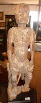 Tribal Art: Ancient African carved wood figure, 70cm high. on museum type plinth