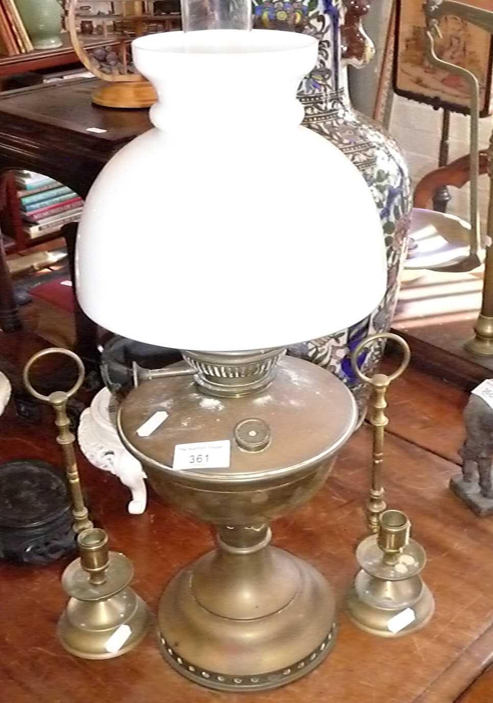 Brass oil lamp and two brass chambersticks