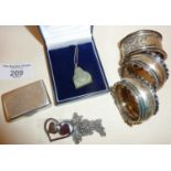 Carved green stone Buddha pendant, silver napkin rings and a silver match case engraved 'The