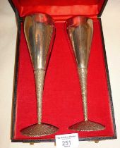 Pair of modernist hammered and textured silver champagne flutes in original case, designed by Stuart