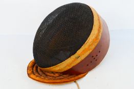 An early 20th century Wilkinson Sword fencing mask,